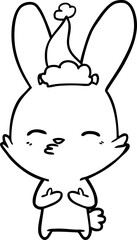 Fototapeta premium curious bunny line drawing of a wearing santa hat