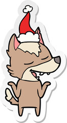 sticker cartoon of a wolf laughing wearing santa hat