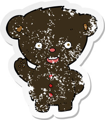 retro distressed sticker of a cartoon waving black bear cub