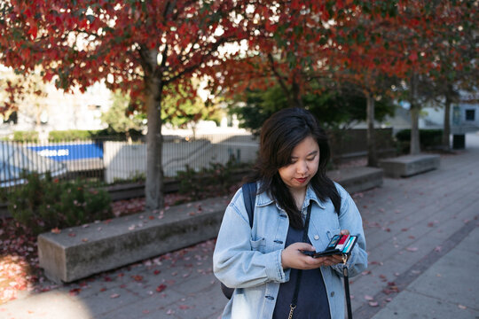 Normal person downtown using cell phone.