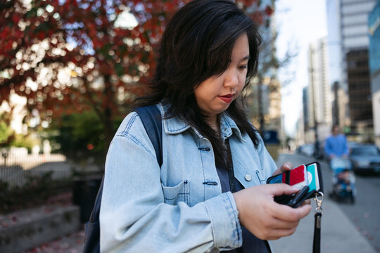 Normal person downtown using cell phone.
