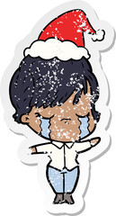 distressed sticker cartoon of a woman crying wearing santa hat