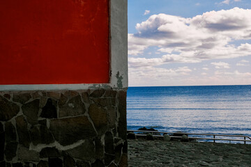 A red facade by the sea.