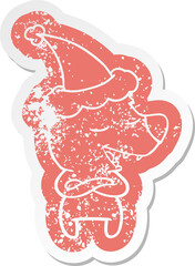 cartoon distressed sticker of a bear wearing santa hat