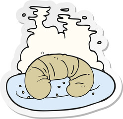 sticker of a cartoon hot croissant