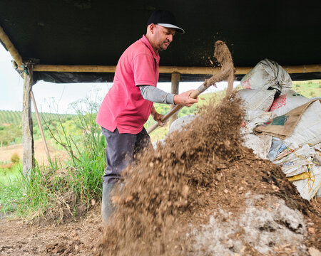Farmer mixing compost