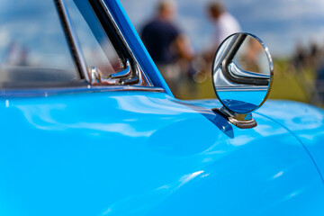 Blue oldtimer car round rearview mirror