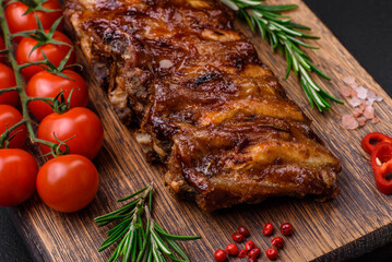 Delicious grilled pork ribs with sauce, spices and herbs
