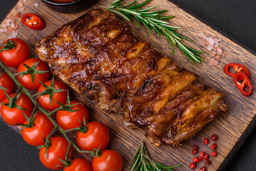 Delicious grilled pork ribs with sauce, spices and herbs