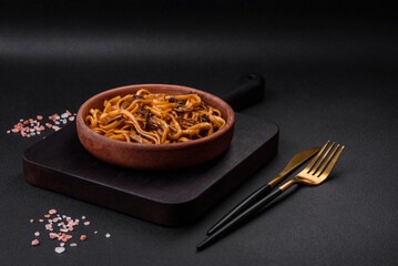 Delicious noodles or udon with mushrooms, salt, spices and herbs