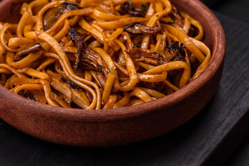 Delicious noodles or udon with mushrooms, salt, spices and herbs