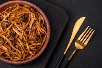 Delicious noodles or udon with mushrooms, salt, spices and herbs