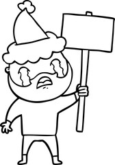 line drawing of a bearded protester crying wearing santa hat