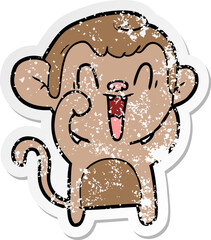 distressed sticker of a cartoon laughing monkey
