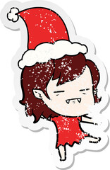 distressed sticker cartoon of a undead vampire girl wearing santa hat