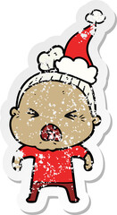 distressed sticker cartoon of a angry old woman wearing santa hat