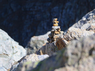 mark made of stones on a trail in the mountains.