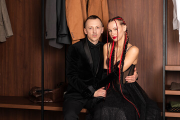 Fototapeta na wymiar Elegant couple in black stylish outfits. Beautiful Woman and man are in love.