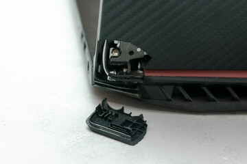 Laptop is broken with arm hinge on the screen,laptop cover,repair loop. cracked plastic laptop...