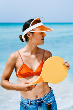 Woman in visor with frescobol paddle