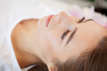 Obraz na płótnie Canvas Young woman getting spa massage treatment at beauty spa salon