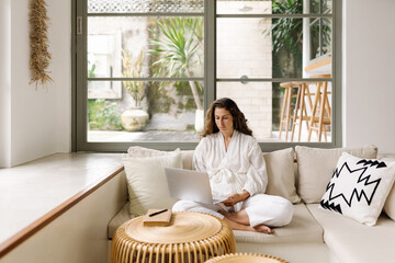 Businesswoman using laptop at home