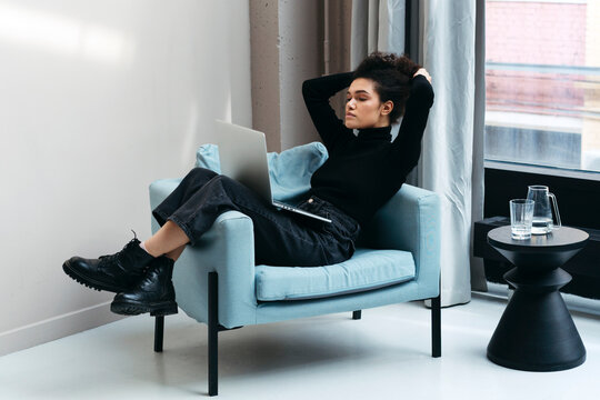 Stylish female freelancer takes break from work.