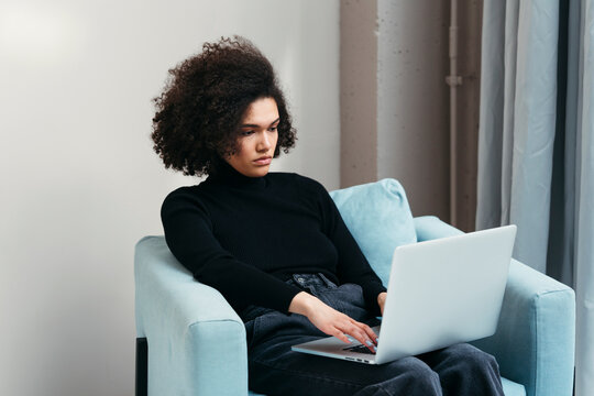Stylish freelancer woman typing on laptop keyboard .