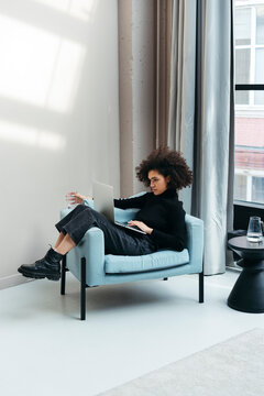 Black female freelancer warking from home.