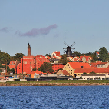 Black old windmill and other buildings in Ebeltoft.