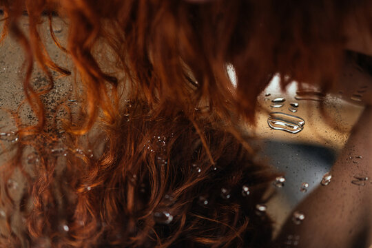 Red hair of woman and the mirror