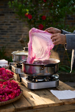 Closeup of fabric being dyed, put into boiled dye water