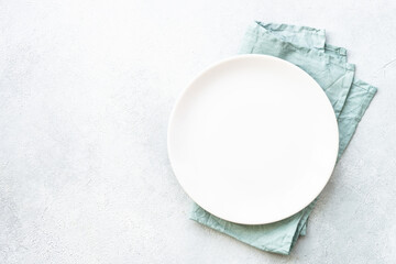 White plate on stone table. Empty plate top view.