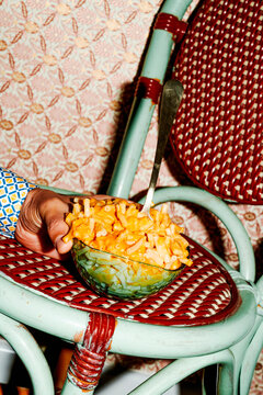 man grabbing a bowl of mac and cheese