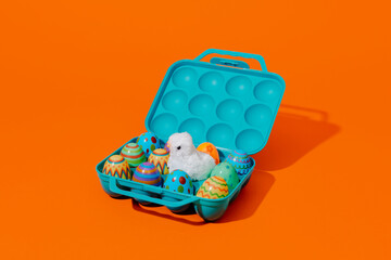 easter eggs and chick in a blue egg box