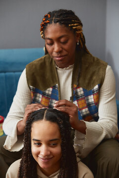 Women talking and braiding thair hair 