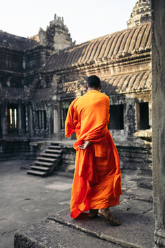 Buddhist monk appreciating the Angkor Wat temple