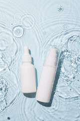 White bottle flacon cosmetics beauty product in water drop