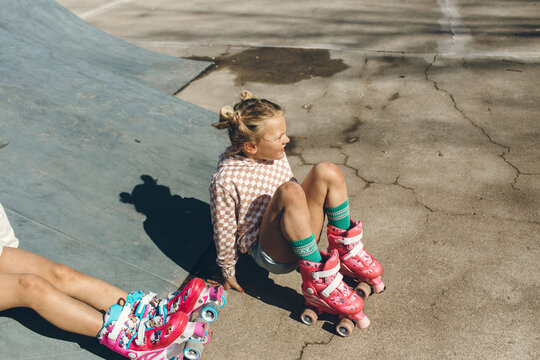 little girl sitting in roller skates