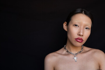 Self-confident young Asian woman with creative makeup and freckles