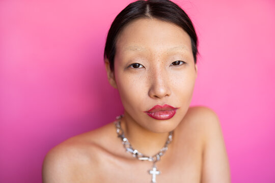 Stylish Asian Woman With Trendy Makeup In Studio Of Pink Background