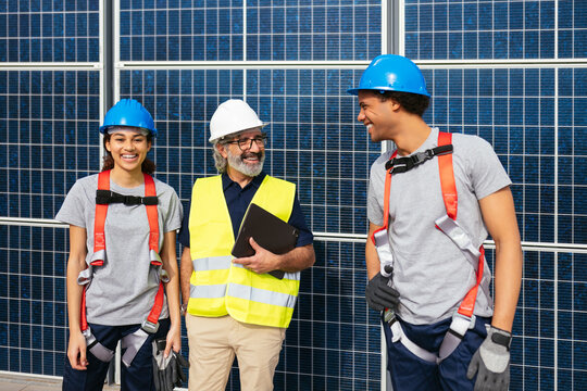 Engineers standing near solar power station