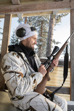 Hunter smiling while loading rifle