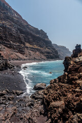 Beach with volcanic stones in the sea at Verodal beach on El Hierro Island. Canary Islands