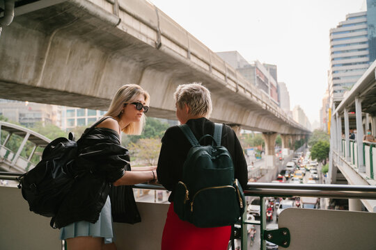 Two Woman Conversation On The Street Of Big City