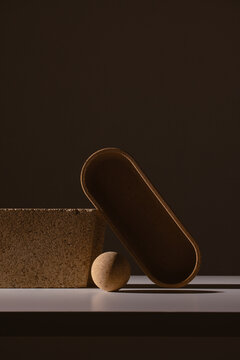 Still life of textured shapes in dark shadow