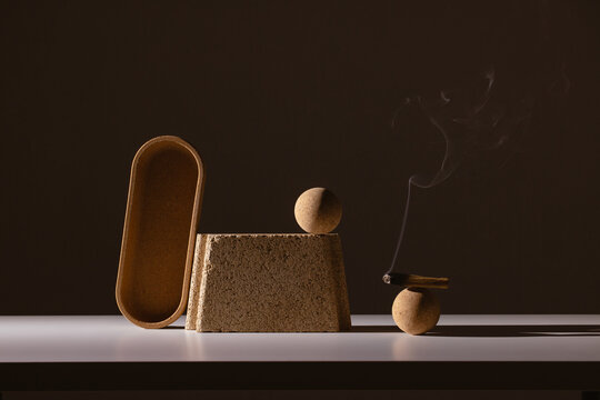 still life of architectural shapes in dramatic light with palo santo