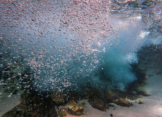 Breathtaking underwater waterfall with sand bottom and millions of bubbles