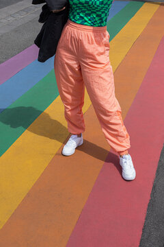 Woman standing on a rainbow colorful floor
