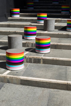 Cylinders on the street stairs draped with the LGBT community flag